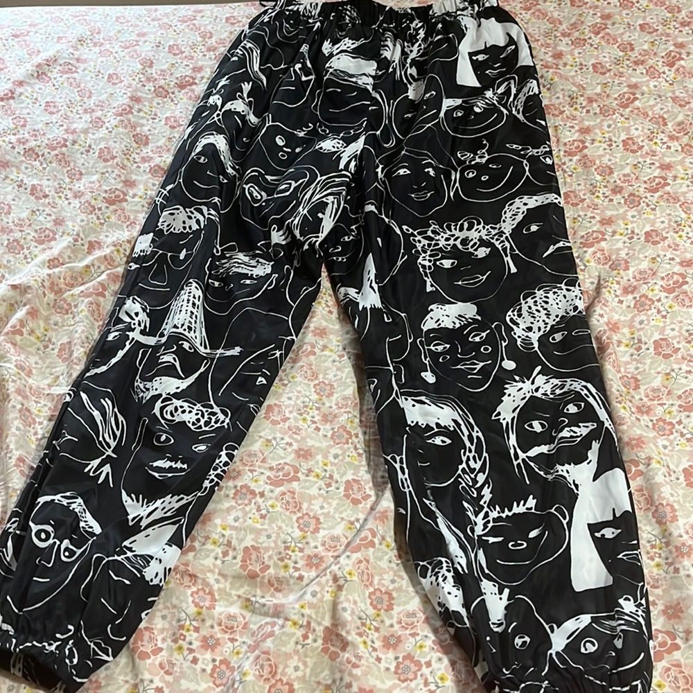 SHEIN XS black tracksuit with faces etched in white.